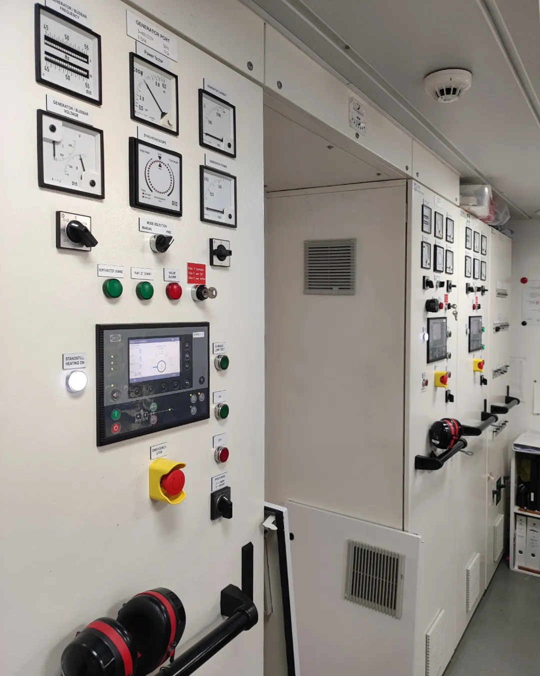 Advanced DEIF Power Management System modules for ship generator synchronization and parallel operation.
